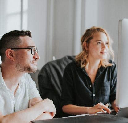 Designers working on an Interface Design Audit at their desk